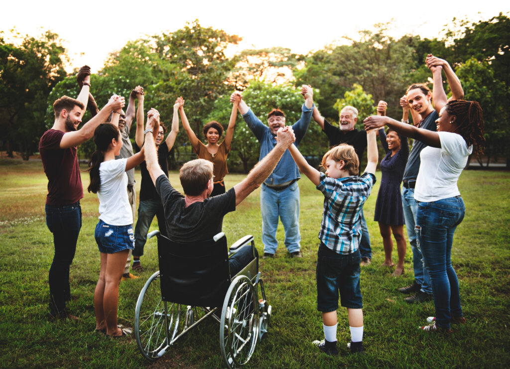 Group of people holding hand together in the park